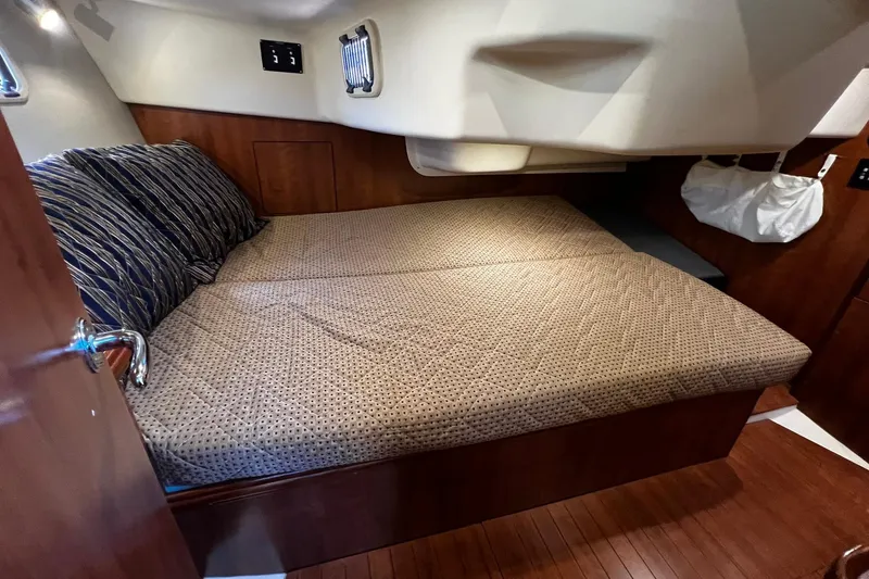 Slide: The Image of Cozy cabin interior of 2015 Hunter 37 sailboat with comfortable bedding and wooden accents. - 29
