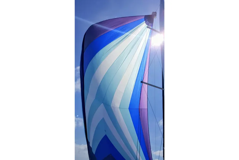 Slide: The Image of Colorful sail of a 2015 Hunter 37 yacht against a bright blue sky. - 61