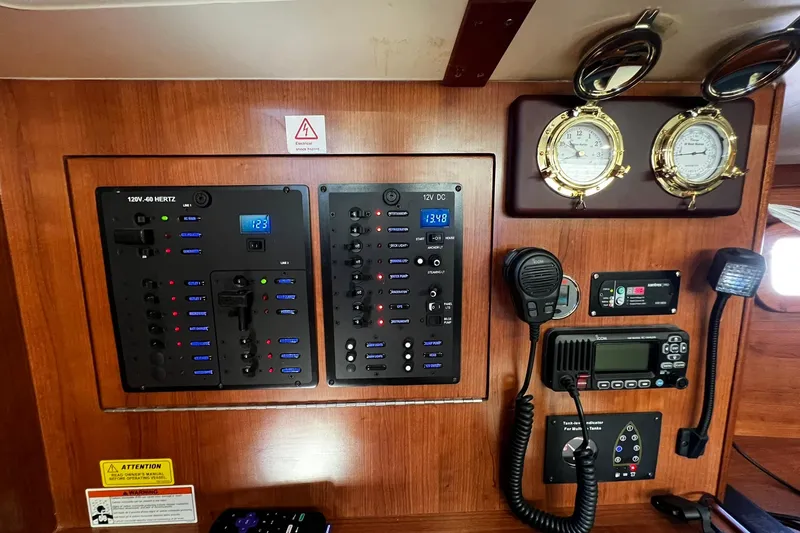Slide: The Image of Electrical control panel on a 2015 Hunter 37 yacht with gauges and communication devices. - 38
