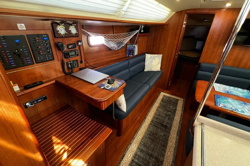Slide: The Image of Interior of a 2015 Hunter 37 sailboat with wood finish and navigation station. - 28