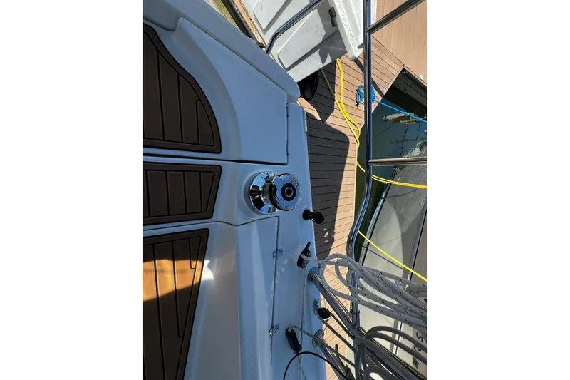 Slide: The Image of 2015 Hunter 37 sailboat deck with winch and ropes, docked at marina. - 3