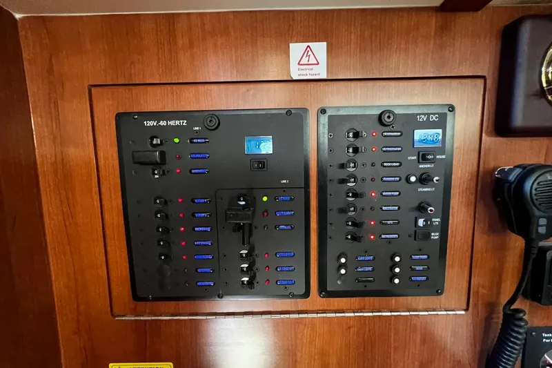Slide: The Image of Electrical control panel on a 2015 Hunter 37 yacht, featuring 120V and 12V systems. - 39