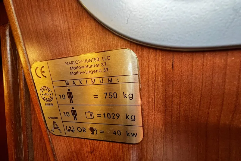 Slide: The Image of Plaque on Hunter 37 sailboat, 2015 model, showing weight and capacity limits. - 58