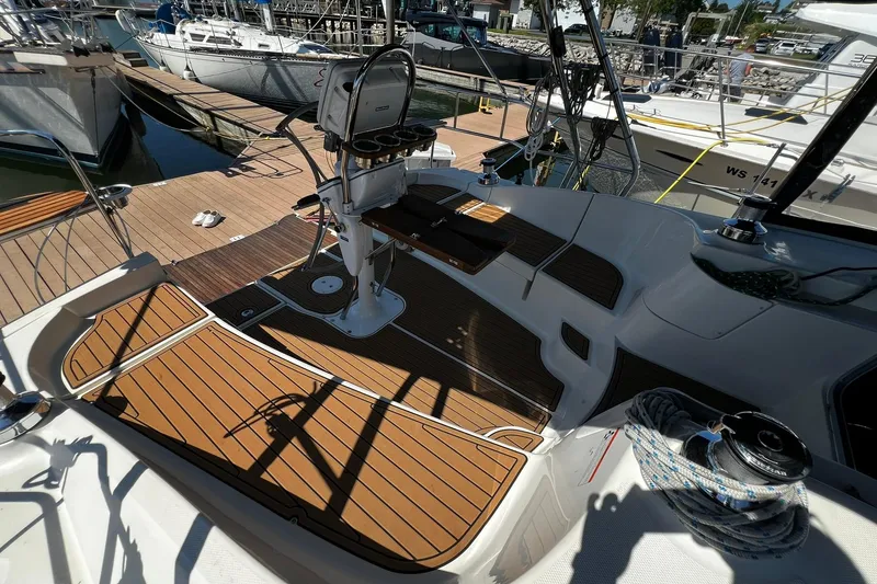 Slide: The Image of Cockpit of 2015 Hunter 37 sailboat with teak flooring and steering wheel at marina. - 12