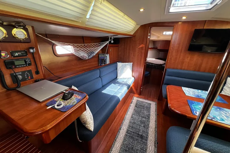 Slide: The Image of Interior of a 2015 Hunter 37 sailboat with cozy seating and navigation equipment. - 57