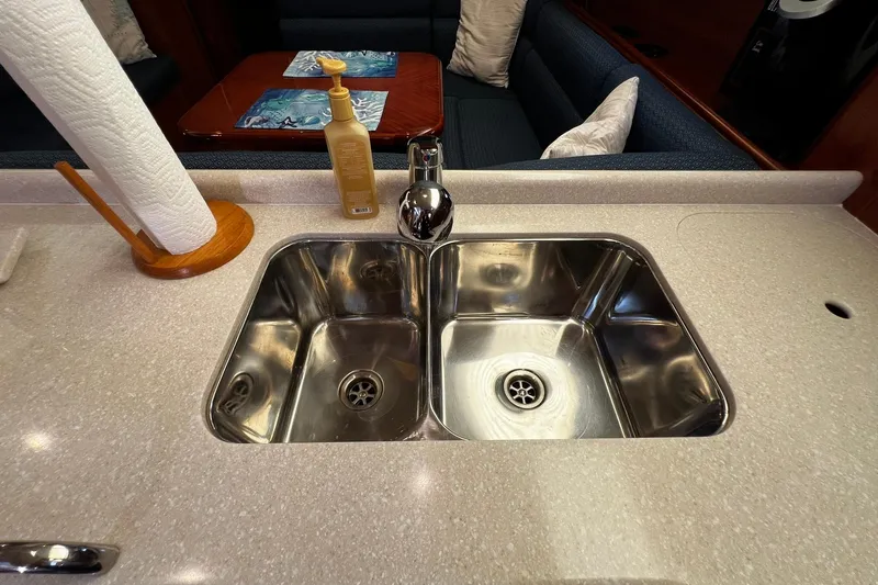Slide: The Image of Modern kitchen sink on a 2015 Hunter 37 yacht with countertop and dining area. - 25