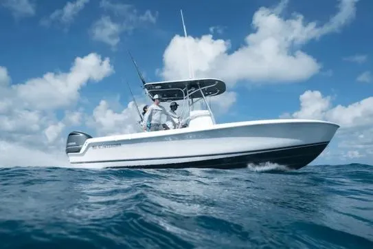 The Image of 2027 Contender 24 Sport boat navigating ocean waves under a clear blue sky. - 1