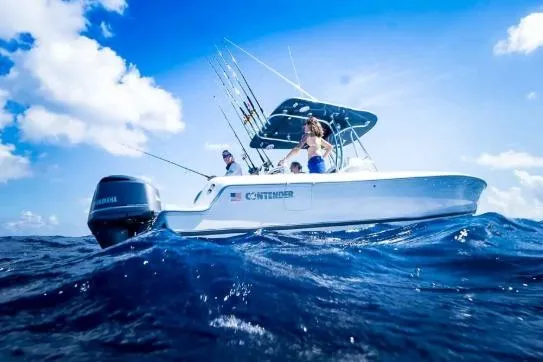 Slide: The Image of 2027 Contender 24 Sport boat on ocean, clear sky, fishing rods visible. - 3