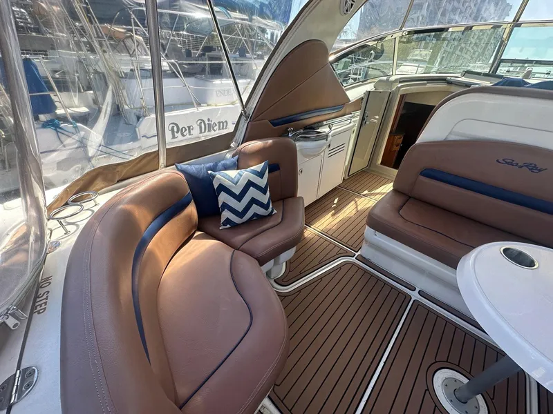 Slide: The Image of The image shows the cockpit of a 2006 Sea Ray 380 Sundancer with elegant seating and wood flooring. - 26