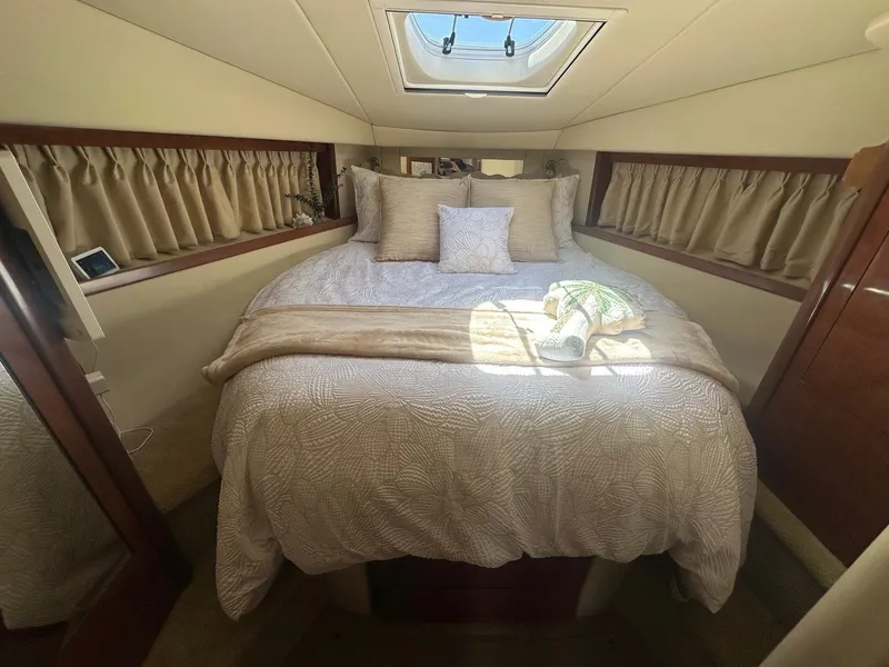 Slide: The Image of Cabin of the 2006 Sea Ray 380 Sundancer with a cozy bed and skylight. - 9