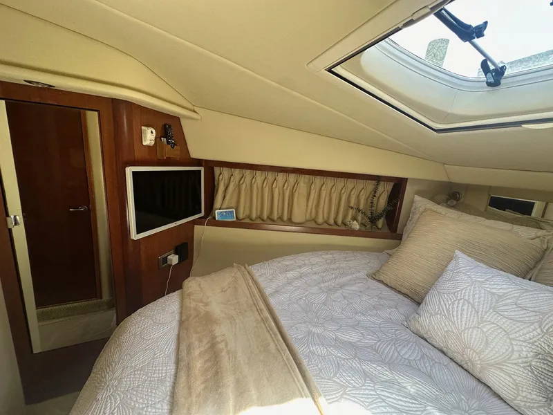Slide: The Image of The 2006 Sea Ray 380 Sundancer cabin features a cozy bed and a skylight. - 10