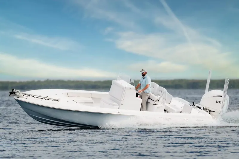 The Image of Manufacturer Provided Image: 2026 Contender 26 Bay boat cruising on water with a clear sky backdrop. - 1