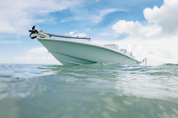 Slide: The Image of 2027 Contender 26 Bay boat on calm ocean under blue sky. - 5