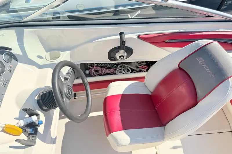 Slide: The Image of Interior of a 2006 Sea Ray 210 Bow Rider boat with red and white seating. - 10