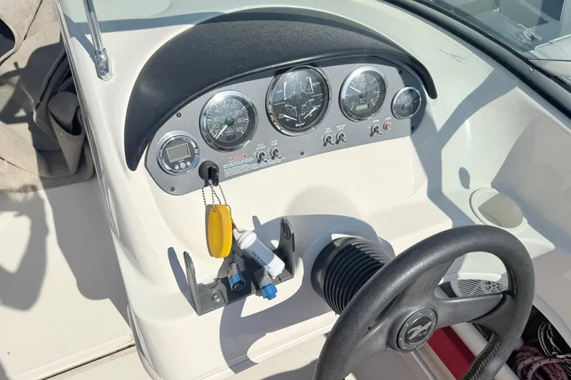 Slide: The Image of Dashboard of a 2006 Sea Ray 210 Bow Rider boat with steering wheel and gauges. - 8