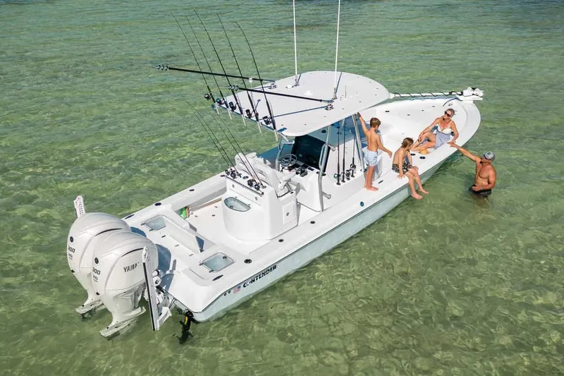 Slide: The Image of Manufacturer Provided Image: 2025 Contender 29 Bay boat with people relaxing in shallow water. - 2