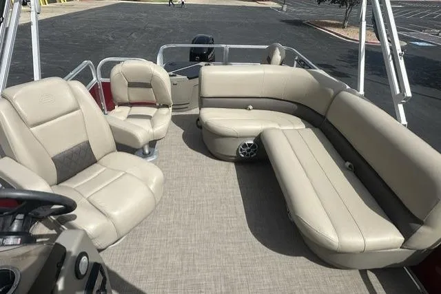 Slide: The Image of 2025 Sun Tracker Bass Buggy 18 DLX pontoon boat interior with beige seating and spacious layout. - 8