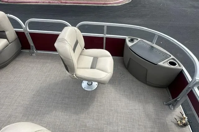 Slide: The Image of 2025 Sun Tracker Bass Buggy 18 DLX pontoon boat interior with seating and storage. - 4