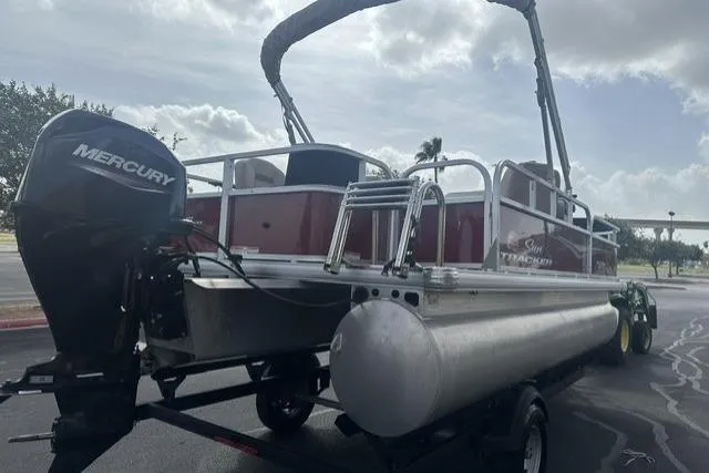 Slide: The Image of 2025 Sun Tracker Bass Buggy 18 DLX pontoon boat with Mercury engine on trailer. - 12