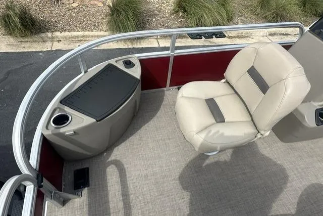 Slide: The Image of 2025 Sun Tracker Bass Buggy 18 DLX pontoon boat interior with beige seating and red accents. - 5