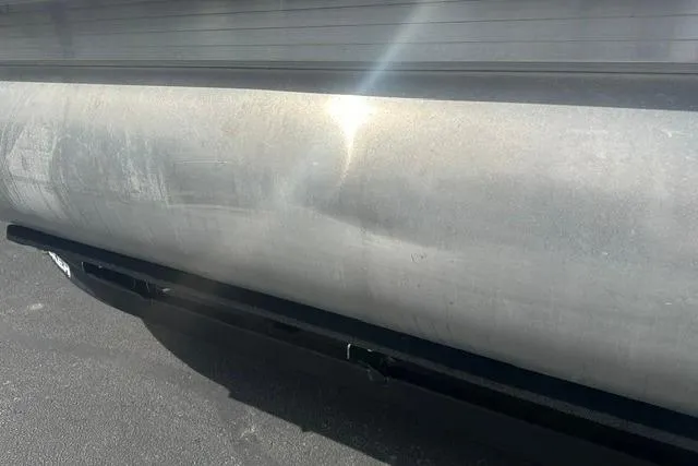 Slide: The Image of 2025 Sun Tracker Bass Buggy 18 DLX pontoon detail with sunlight reflection. - 13