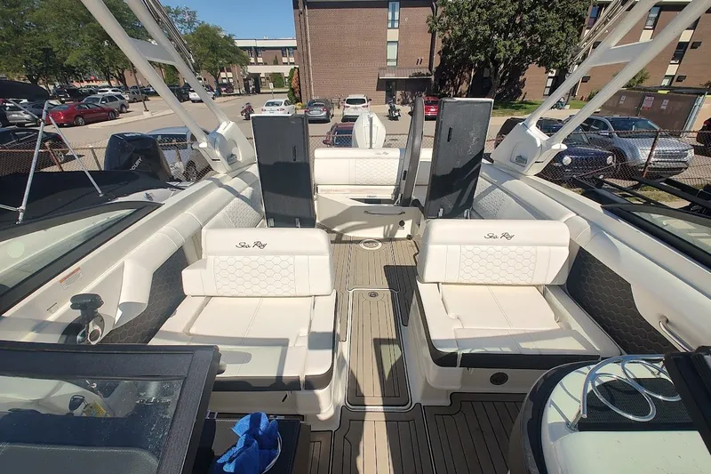 Slide: The Image of 2021 Sea Ray SDX 270 Outboard boat interior with white seating and modern design. - 14