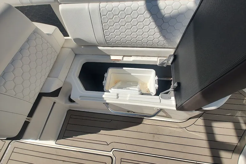 Slide: The Image of 2021 Sea Ray SDX 270 Outboard boat interior with open storage compartment. - 15