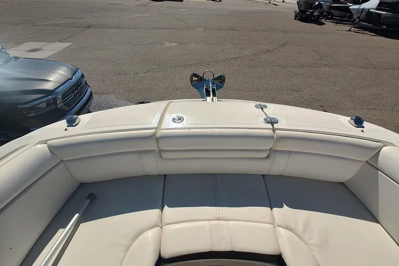 Slide: The Image of 2021 Sea Ray SDX 270 Outboard boat interior with white seating and anchor. - 21