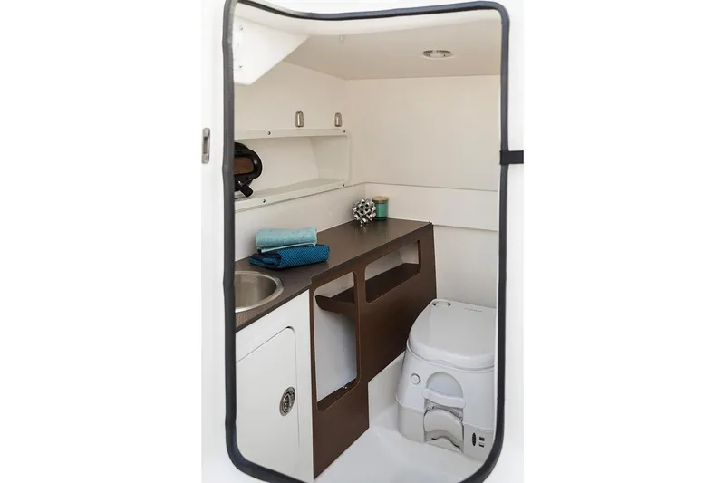 Slide: The Image of Manufacturer Provided Image: 2021 Sea Ray SDX 270 Outboard boat interior bathroom with sink and toilet. - 8