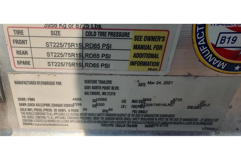Slide: The Image of Label on a 2021 Sea Ray SDX 270 Outboard trailer, detailing tire specifications and pressure. - 12
