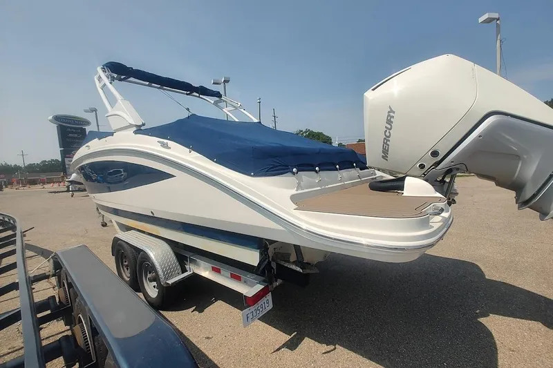 Slide: The Image of 2021 Sea Ray SDX 270 Outboard boat on trailer with Mercury engine, covered in blue tarp. - 5