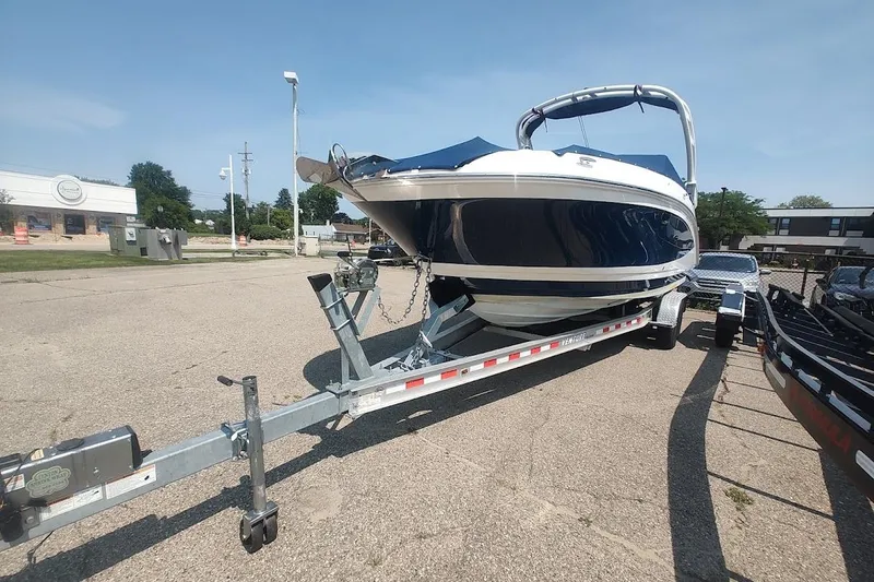 Slide: The Image of 2021 Sea Ray SDX 270 Outboard boat on trailer in parking lot, sunny day. - 3