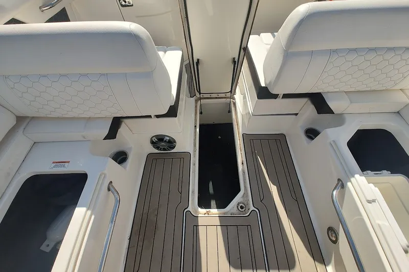 Slide: The Image of 2021 Sea Ray SDX 270 Outboard interior with white seating and teak flooring. - 16