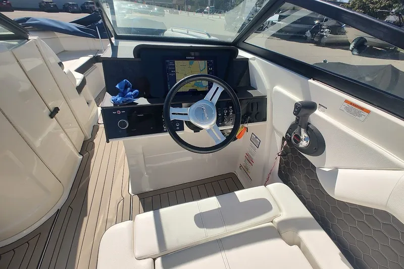 Slide: The Image of 2021 Sea Ray SDX 270 Outboard helm with steering wheel and navigation display. - 17