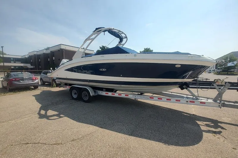Slide: The Image of 2021 Sea Ray SDX 270 Outboard boat on trailer in parking lot. - 0