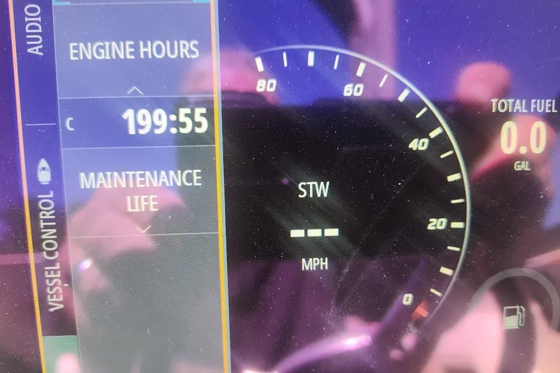 Slide: The Image of Dashboard of 2021 Sea Ray SDX 270 Outboard showing engine hours and fuel level. - 26