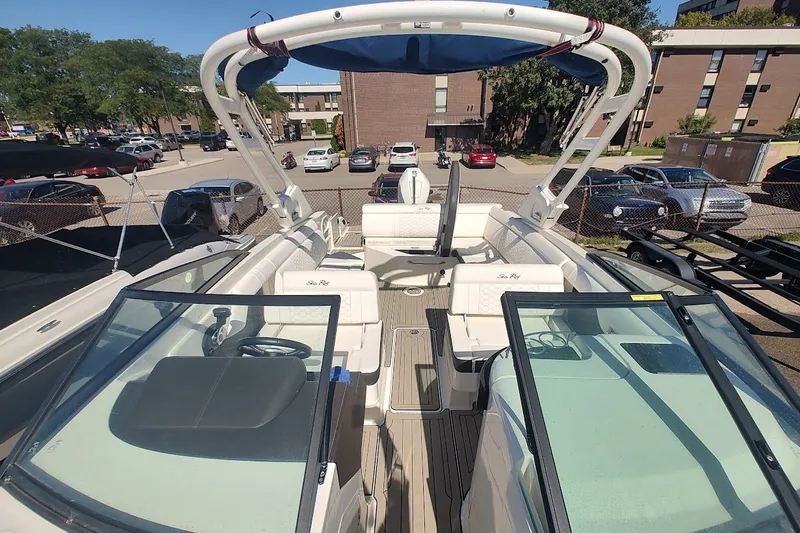 Slide: The Image of 2021 Sea Ray SDX 270 Outboard boat with spacious seating and modern design in a parking lot. - 22