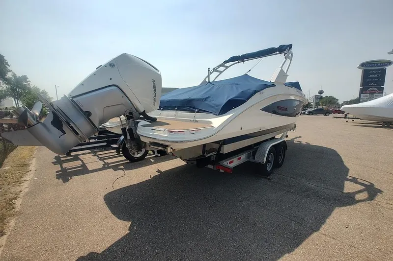 Slide: The Image of 2021 Sea Ray SDX 270 Outboard boat on trailer, covered and parked outdoors. - 4