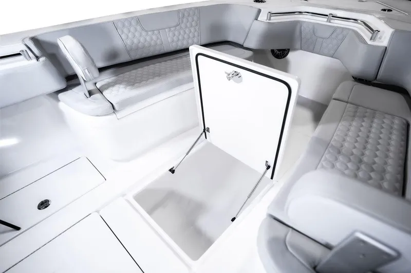 Slide: The Image of Manufacturer Provided Image: 2026 Contender 30 ST boat interior with open storage compartment and cushioned seating. - 8