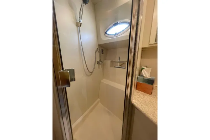 Slide: The Image of Shower area in 2002 Silverton 392 Motor Yacht with porthole and modern fixtures. - 22
