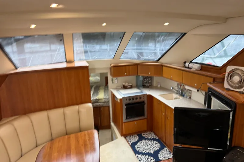 Slide: The Image of Interior of 2002 Silverton 392 Motor Yacht with kitchen and seating area. - 40