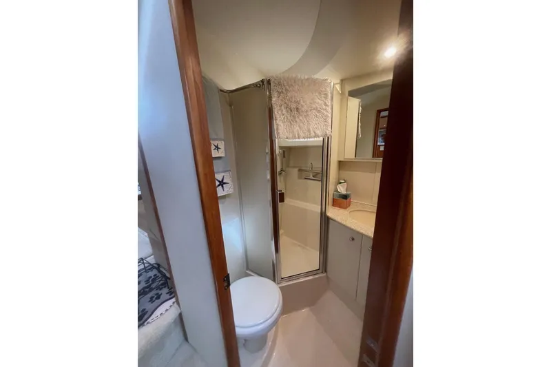 Slide: The Image of Bathroom interior of 2002 Silverton 392 Motor Yacht with shower and vanity. - 21