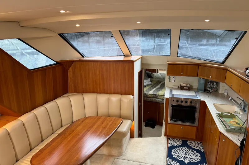 Slide: The Image of Interior of 2002 Silverton 392 Motor Yacht with cozy seating and modern kitchen amenities. - 45