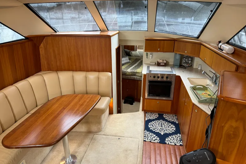 Slide: The Image of Interior of 2002 Silverton 392 Motor Yacht with kitchen and dining area. - 42