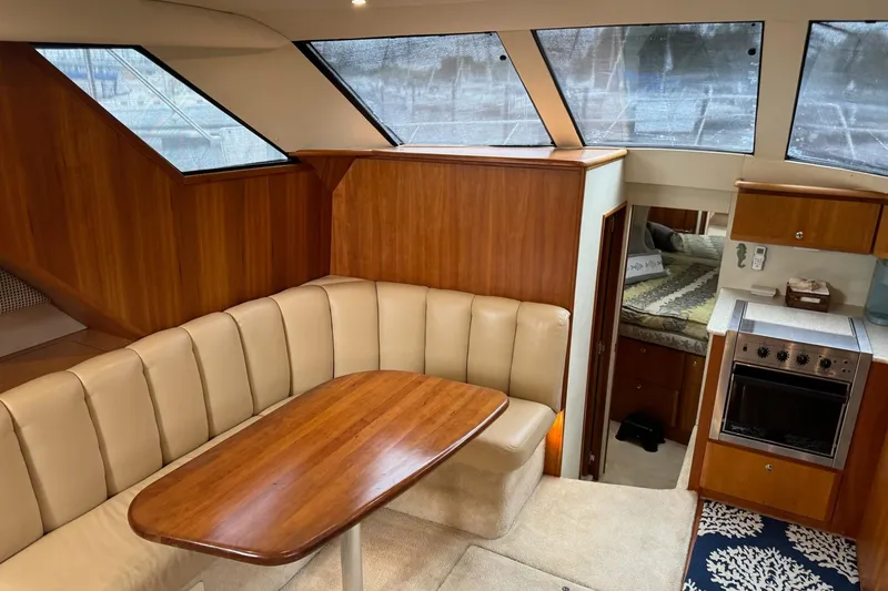 Slide: The Image of Interior of 2002 Silverton 392 Motor Yacht with dining area and kitchen. - 43