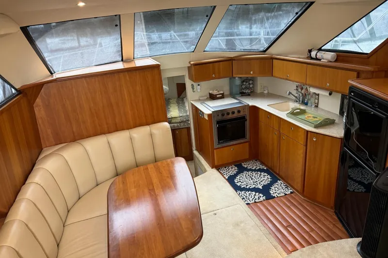 Slide: The Image of Interior of 2002 Silverton 392 Motor Yacht with kitchen and dining area. - 41