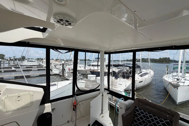 Slide: The Image of Interior view of 2002 Silverton 392 Motor Yacht overlooking marina with docked boats. - 10