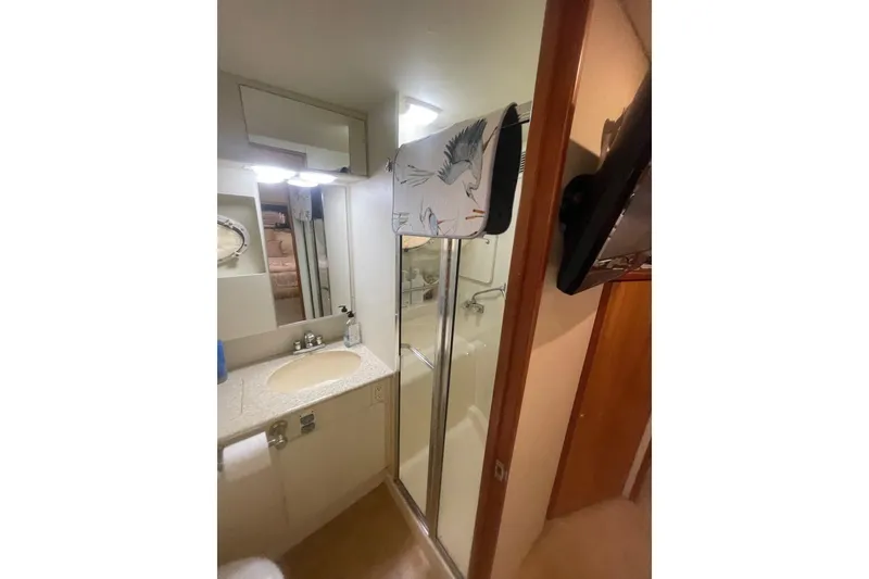 Slide: The Image of Bathroom interior of 2002 Silverton 392 Motor Yacht with shower and sink. - 16