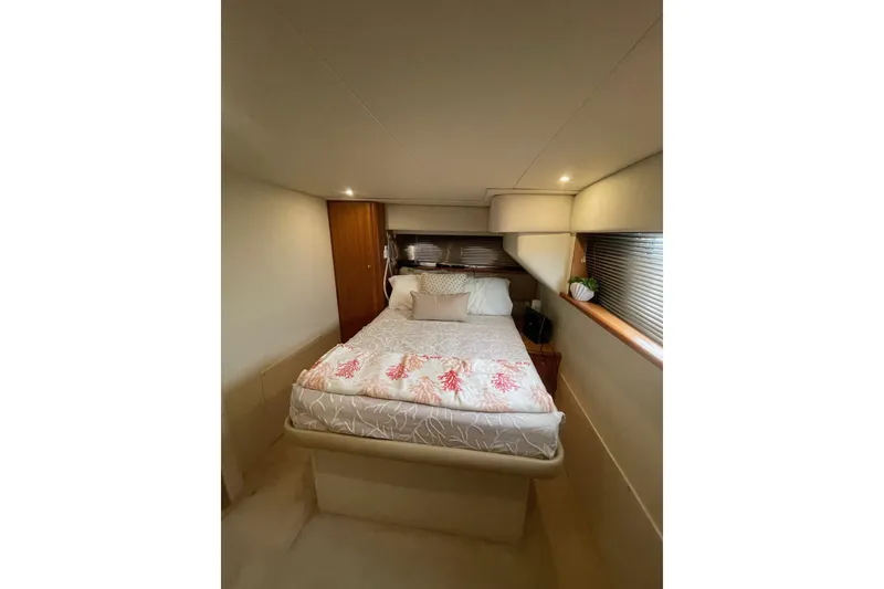 Slide: The Image of Cozy bedroom interior of 2002 Silverton 392 Motor Yacht with elegant bedding and soft lighting. - 19