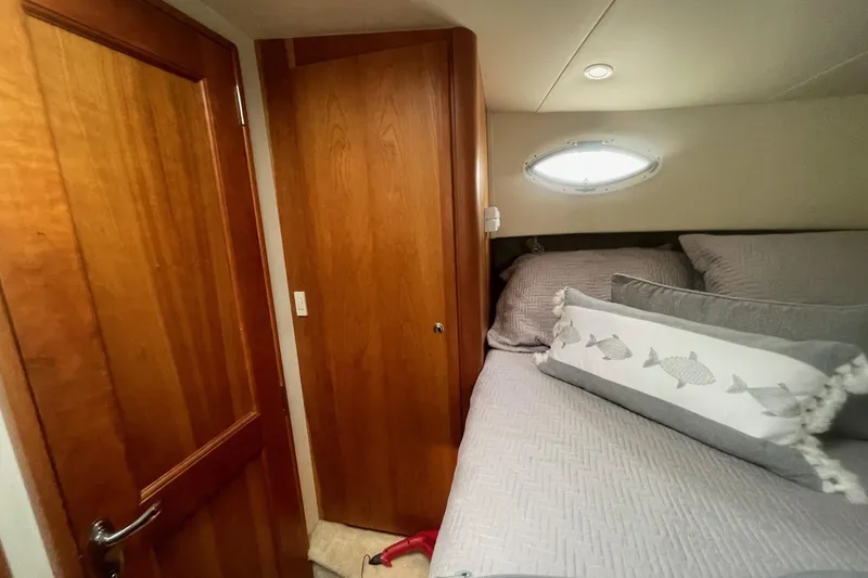 Slide: The Image of Cozy cabin interior of 2002 Silverton 392 Motor Yacht with wooden door and plush bedding. - 23